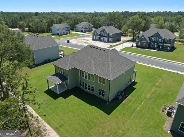 a view of a house with pool and a yard