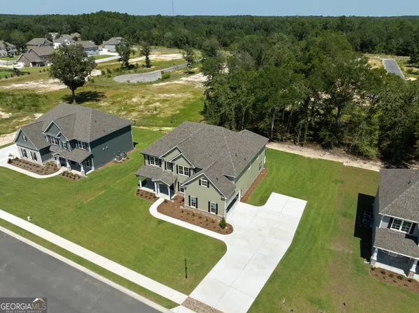 an aerial view of a house with a garden