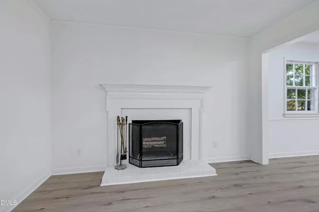 a living room with a fireplace and a fireplace