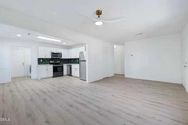 a view of kitchen with a sink wooden cabinet and refrigerator