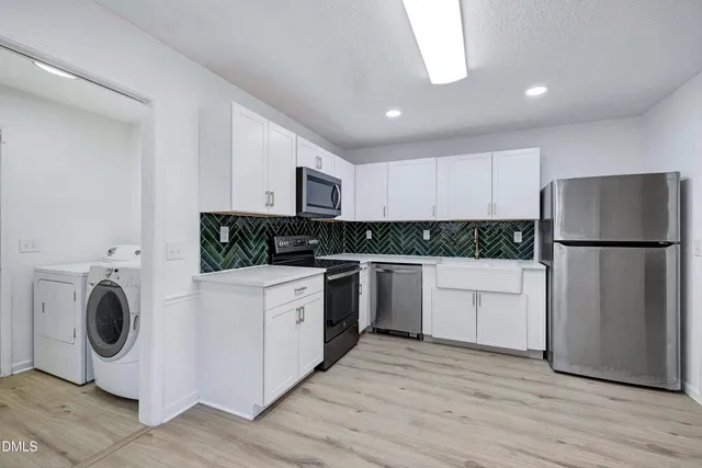 a kitchen with a refrigerator sink and cabinets