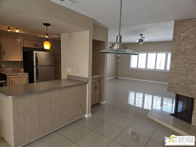 a kitchen with stainless steel appliances granite countertop a stove a refrigerator and a sink