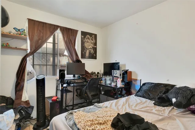 a bedroom with a bed a dresser and mirror