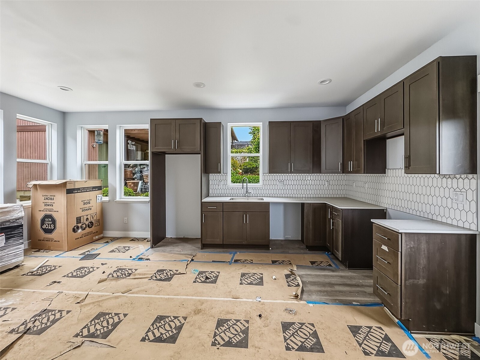 2317 22nd Avenue South Seattle, WA 98144 - Photo 12 of 29 a kitchen with stainless steel appliances kitchen island granite countertop a refrigerator and a stove top oven