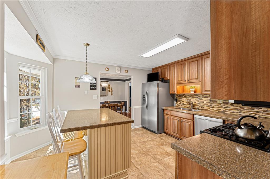 190 Timber Ridge Drive McDonough, GA 30252 - Photo 11 of 29 a kitchen with stainless steel appliances granite countertop a sink stove and refrigerator
