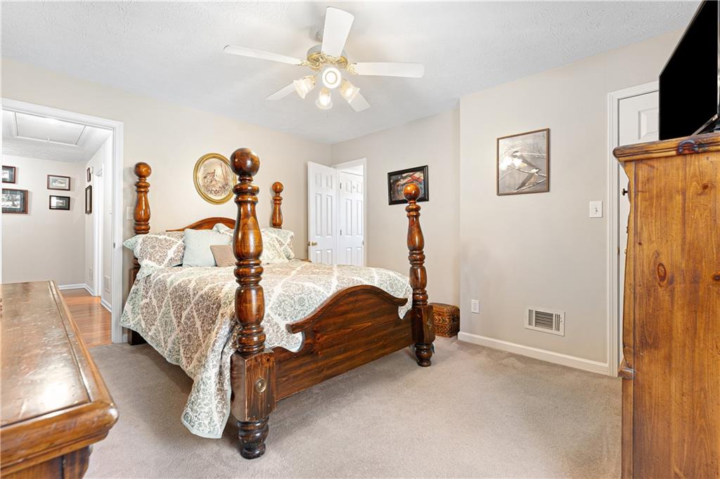 190 Timber Ridge Drive McDonough, GA 30252 - Photo 17 of 29 a bed room with a bed and a chandelier