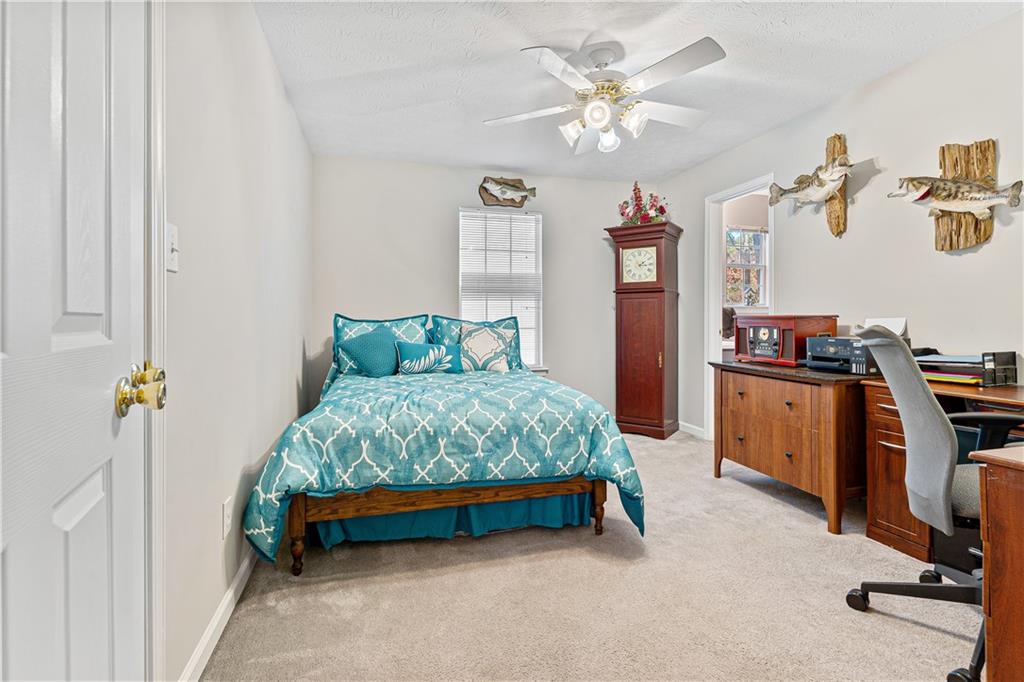 190 Timber Ridge Drive McDonough, GA 30252 - Photo 19 of 29 a bedroom with a bed and a chandelier