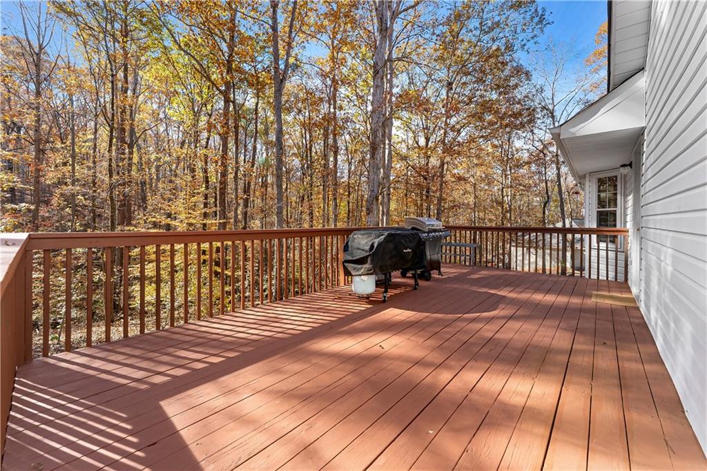 190 Timber Ridge Drive McDonough, GA 30252 - Photo 22 of 29 a view of a patio with table and chairs with wooden floor and fence