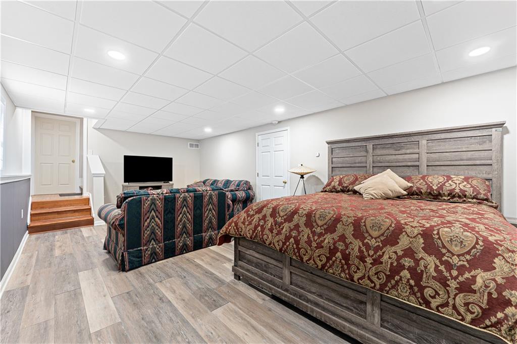 190 Timber Ridge Drive McDonough, GA 30252 - Photo 23 of 29 a spacious bedroom with a bed and a flat screen tv