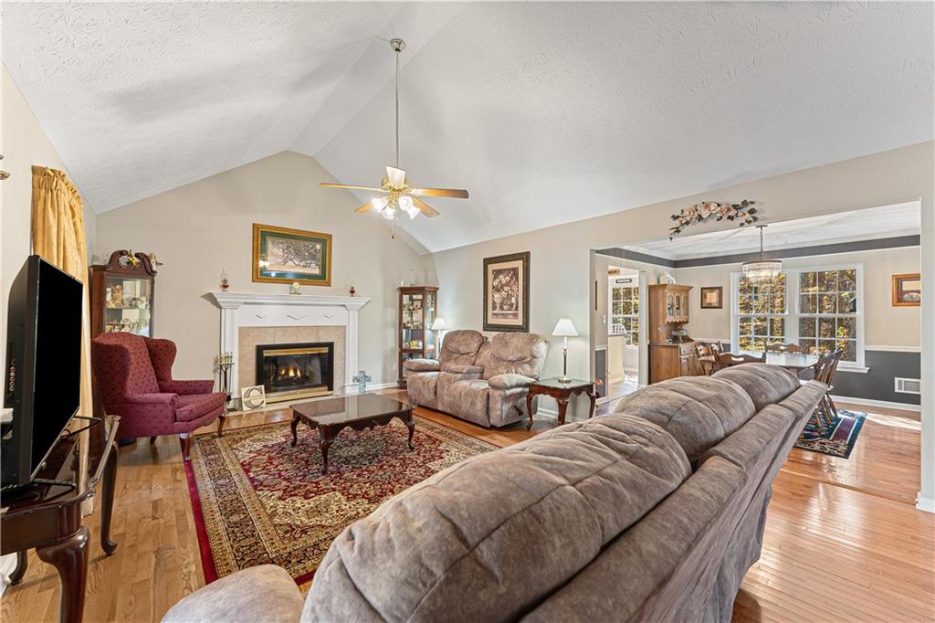 190 Timber Ridge Drive McDonough, GA 30252 - Photo 3 of 29 a living room with furniture a chandelier and a fireplace