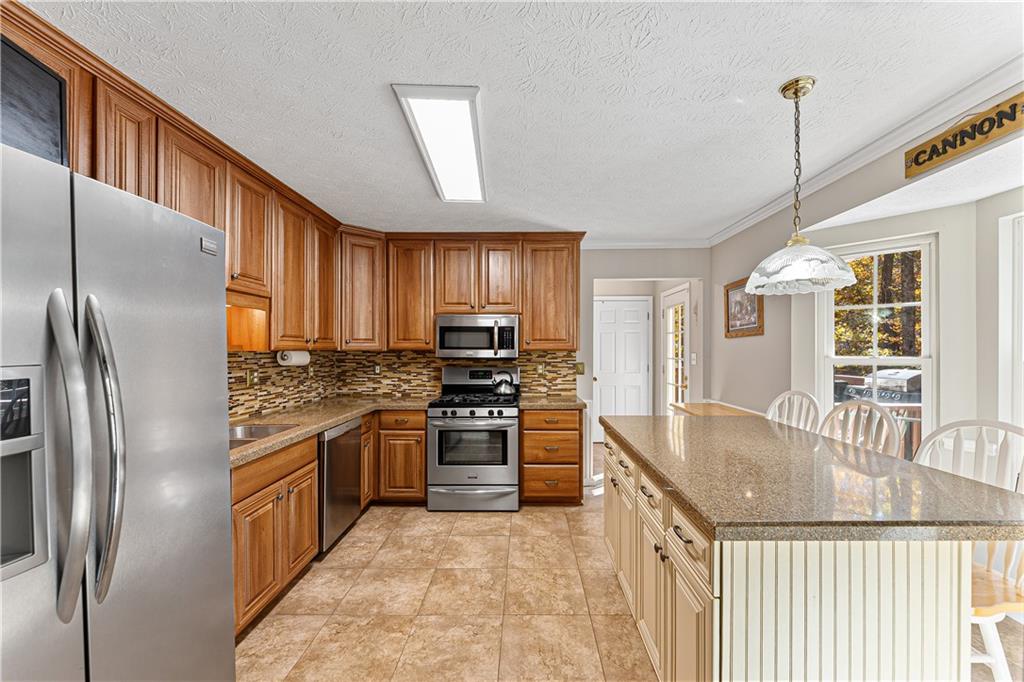 190 Timber Ridge Drive McDonough, GA 30252 - Photo 5 of 29 a kitchen with stainless steel appliances granite countertop a stove refrigerator sink and dishwasher