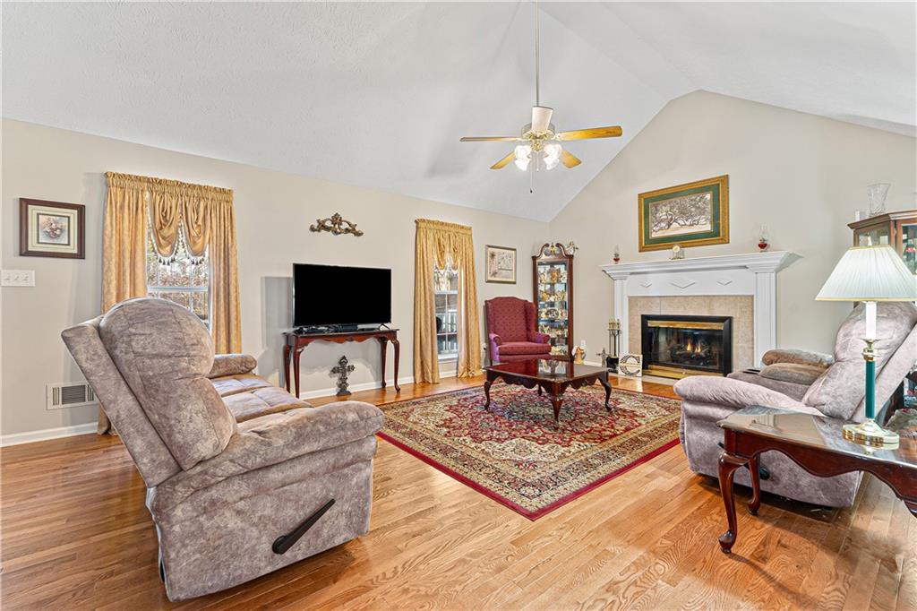 190 Timber Ridge Drive McDonough, GA 30252 - Photo 7 of 29 a living room with furniture a flat screen tv and a fireplace