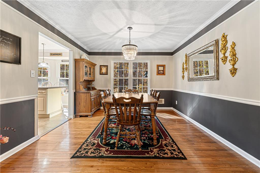 190 Timber Ridge Drive McDonough, GA 30252 - Photo 9 of 29 a living room with furniture dining table and a chandelier