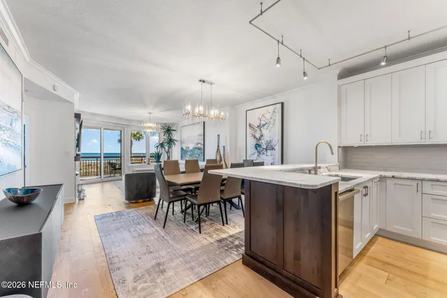 a view of kitchen with sink and living room