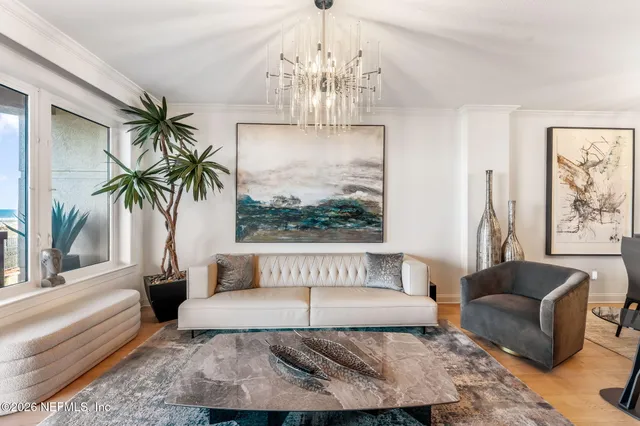 a living room with furniture and a chandelier