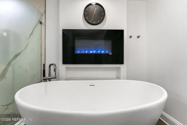 a white bath tub sitting in a bathroom