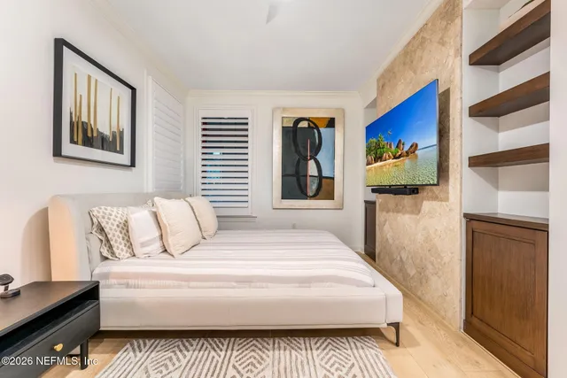 a spacious bedroom with a bed and a cabinets