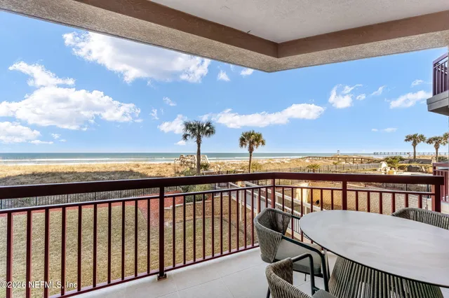 a view of a balcony with an outdoor seating