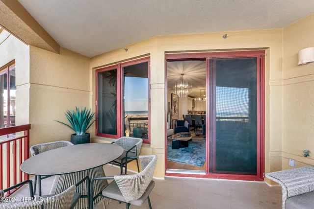 a view of a dining room with furniture and a potted plant