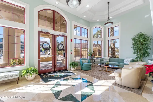 a lobby with furniture and flowers