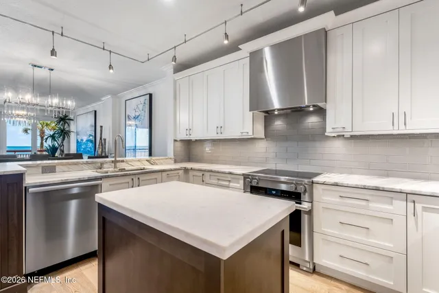 a kitchen with a stove and a white cabinets