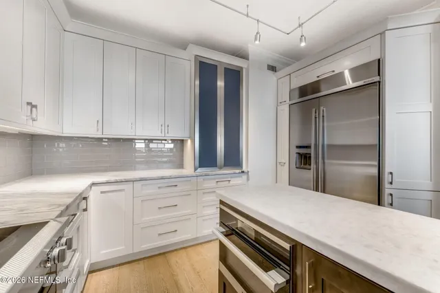 a kitchen with cabinets and stainless steel appliances