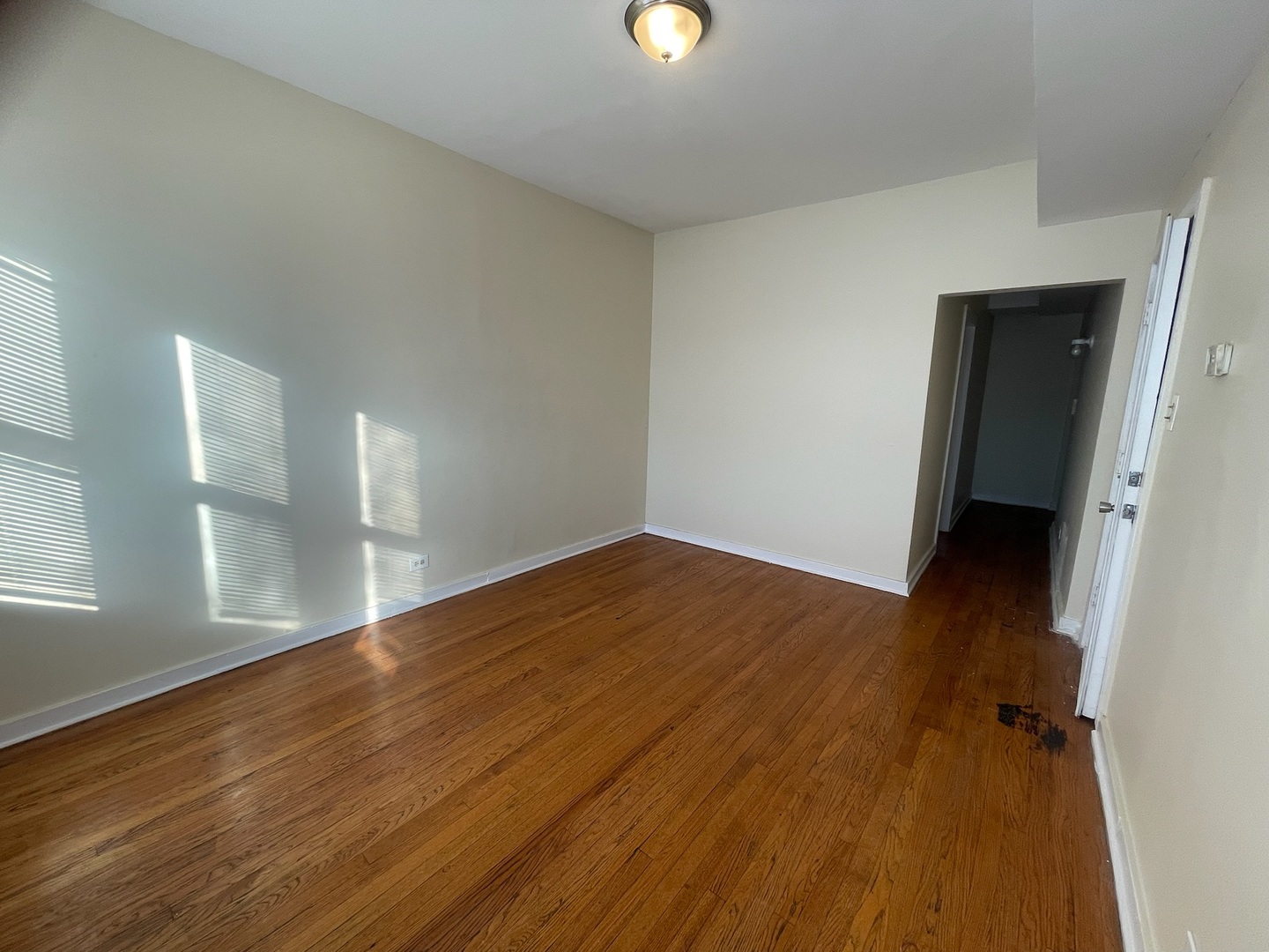 7955 South Emerald Avenue, Unit 2 Chicago, IL 60620 - Photo 3 of 11 wooden floor in an empty room with a window