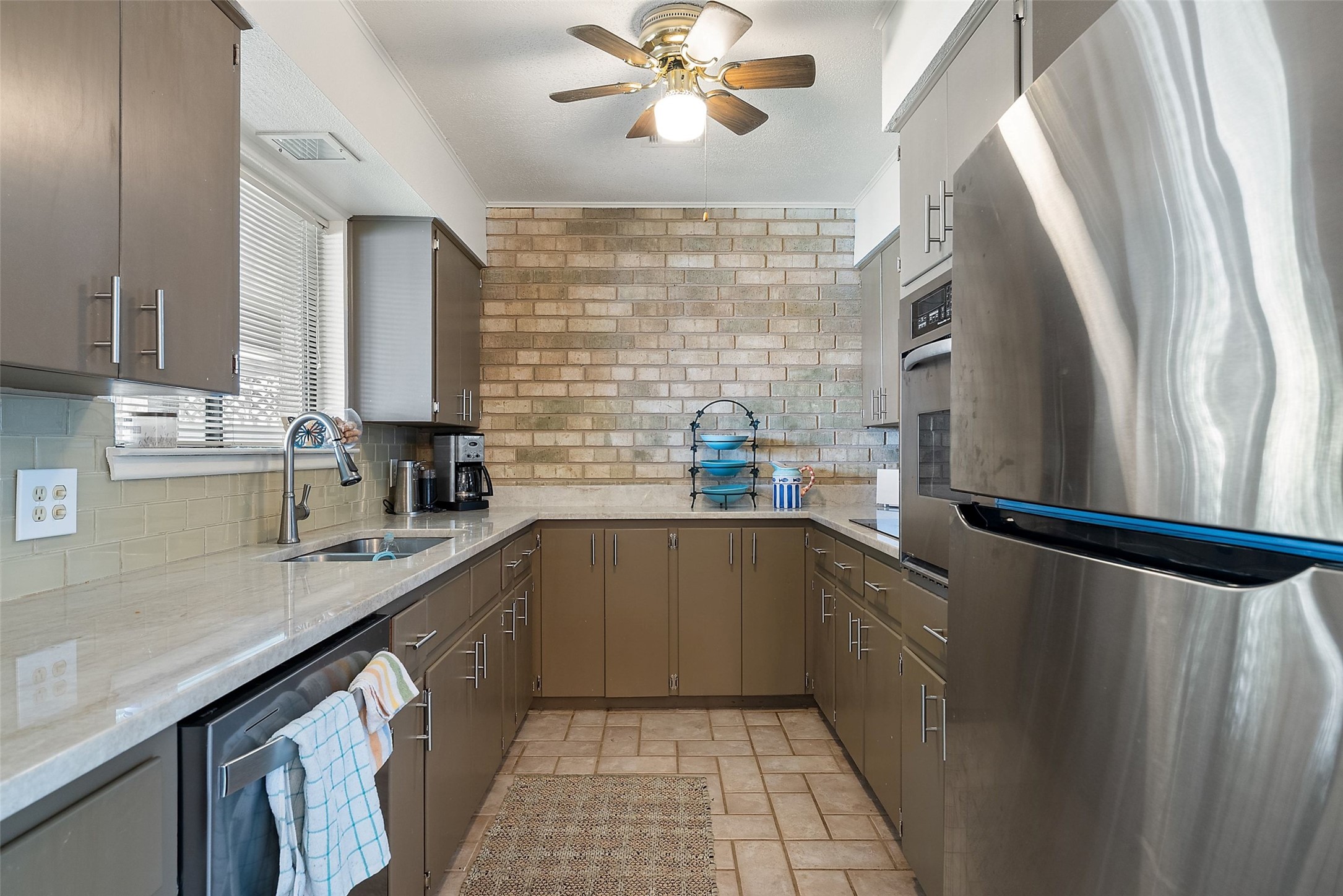 141 Perry Lane Kingsland, TX 78639 - Photo 22 of 40 A well-equipped kitchen features ample cabinetry, stone counters, and modern appliances.
