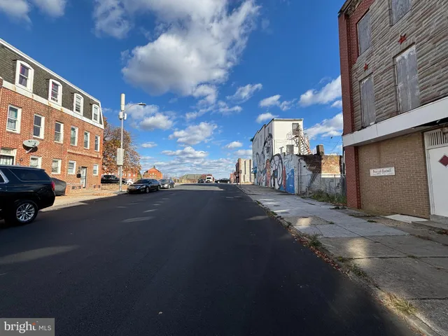 a city street lined with buildings and cars on city street