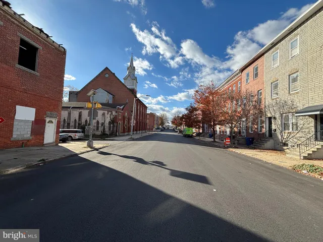 a view of a street with a building in the background