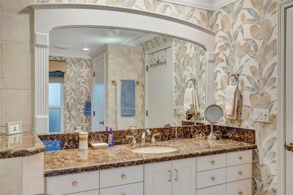 4859 Greencroft Road Sarasota, FL 34235 - Photo 15 of 39 a bathroom with a granite countertop sink a mirror and a shower