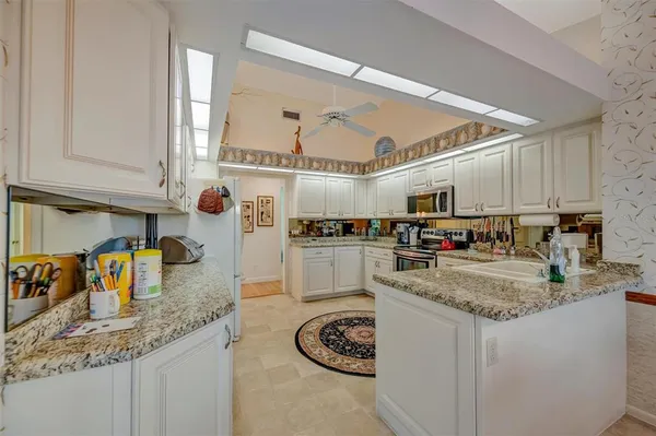 a kitchen with stainless steel appliances granite countertop a sink and cabinets