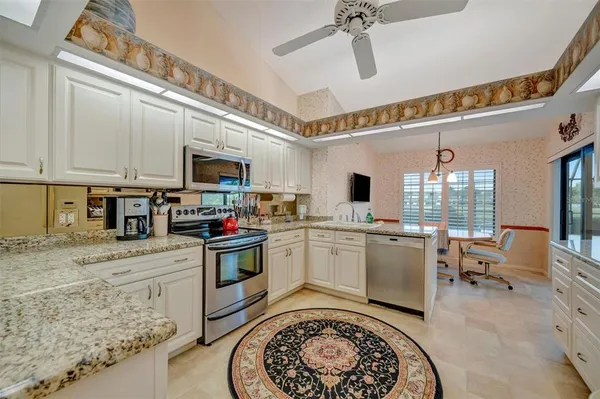 a kitchen with a stove a sink and a refrigerator