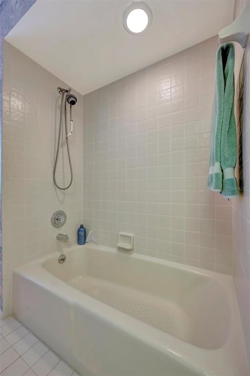 4859 Greencroft Road Sarasota, FL 34235 - Photo 26 of 39 a bathroom with a bath tub with a shower