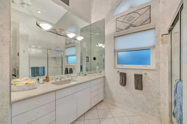 a bathroom with a double vanity sink and a mirror