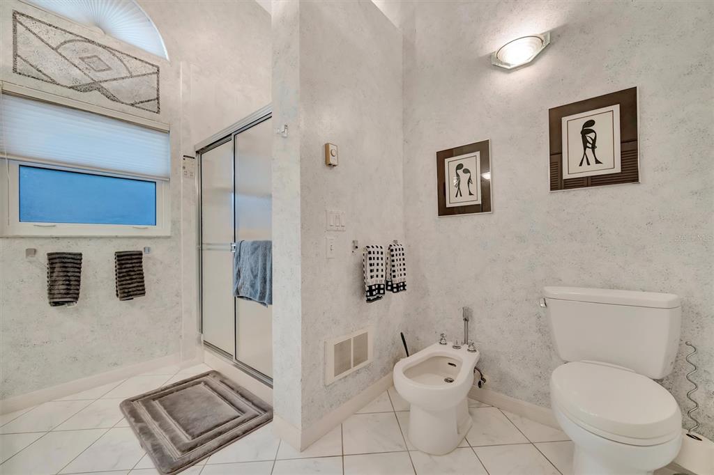 4859 Greencroft Road Sarasota, FL 34235 - Photo 30 of 39 a white toilet sitting next to a bathroom sink