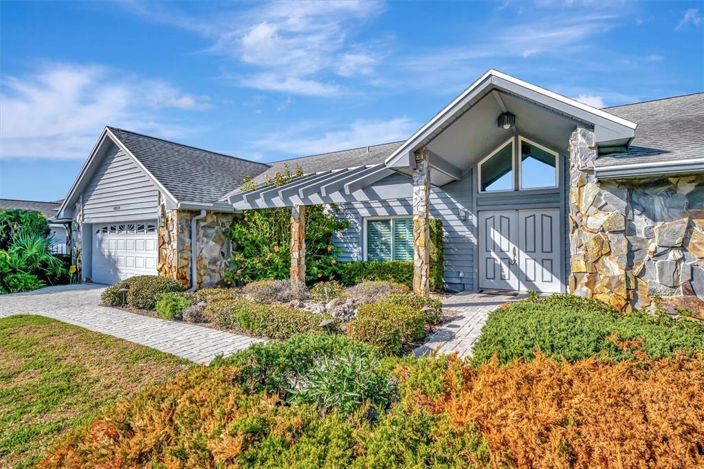 4859 Greencroft Road Sarasota, FL 34235 - Photo 3 of 39 a front view of a house with garden