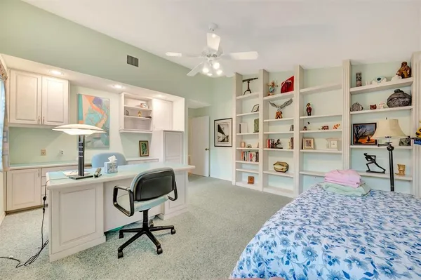 a bedroom with a workspace