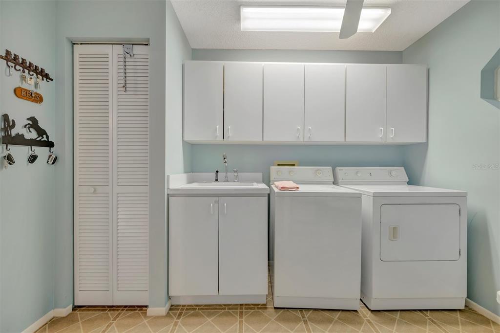 4859 Greencroft Road Sarasota, FL 34235 - Photo 34 of 39 a utility room with dryer and washer