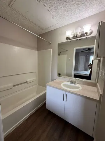 a bathroom with a tub sink and a mirror