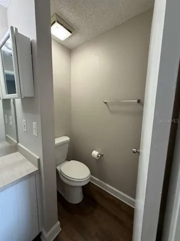 a bathroom with a toilet and a mirror
