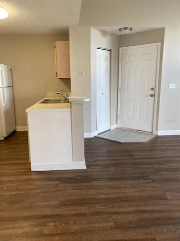 a kitchen with a stove a sink and a refrigerator