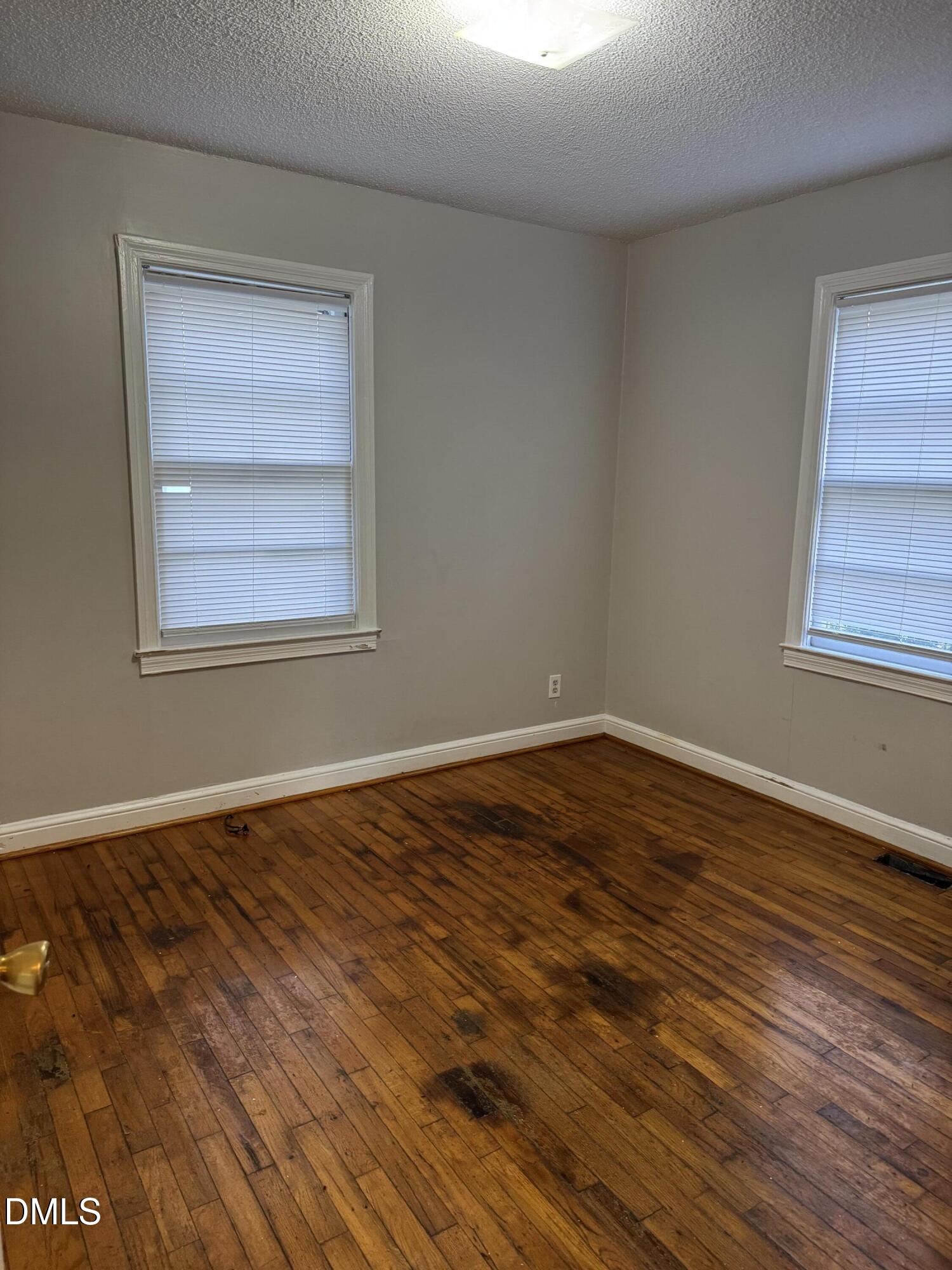 101 Joy Street Dunn, NC 28334 - Photo 8 of 14 a view of an empty room with wooden floor and a window