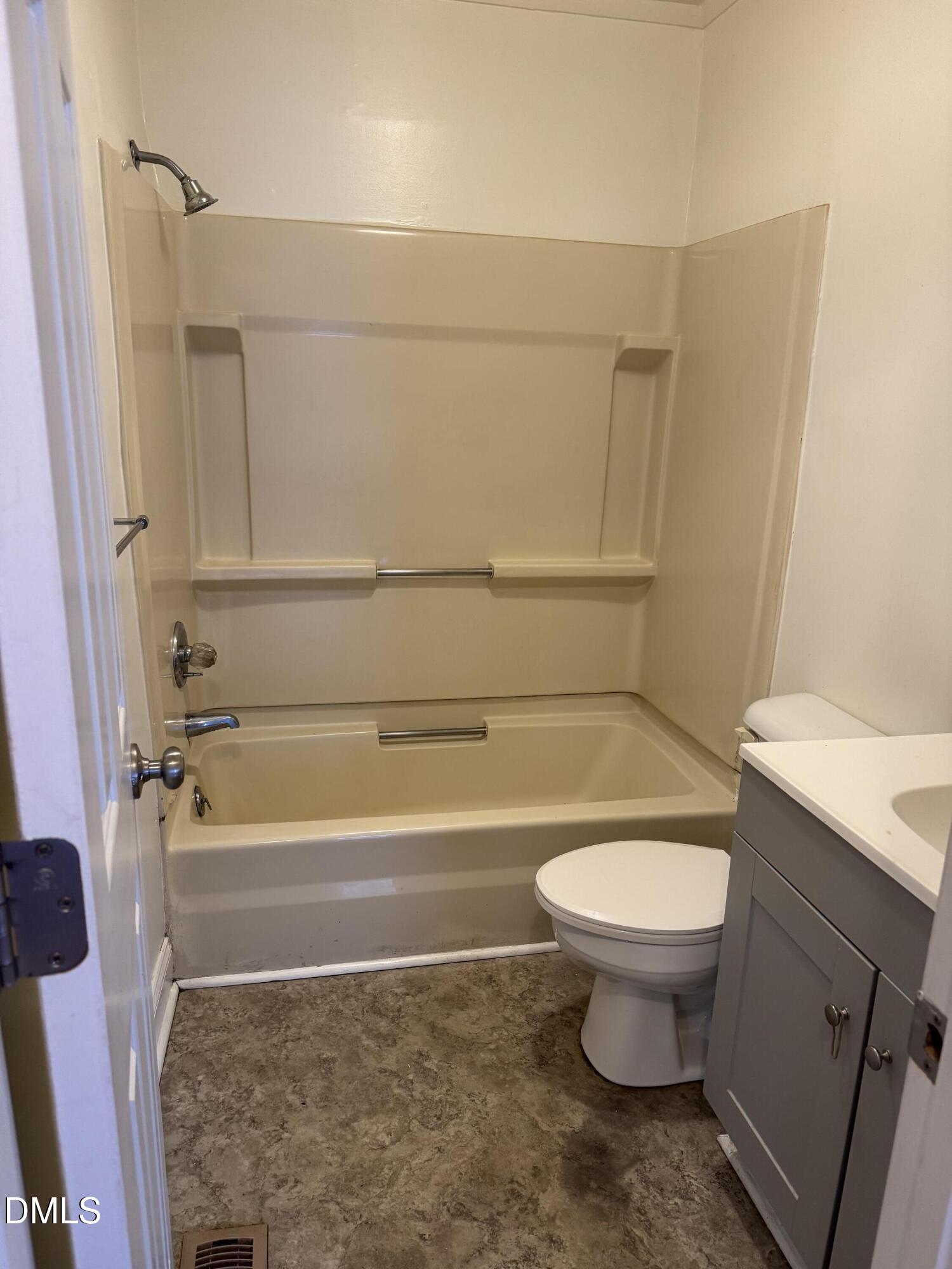 101 Joy Street Dunn, NC 28334 - Photo 9 of 14 a bathroom with a toilet a sink and a bathtub