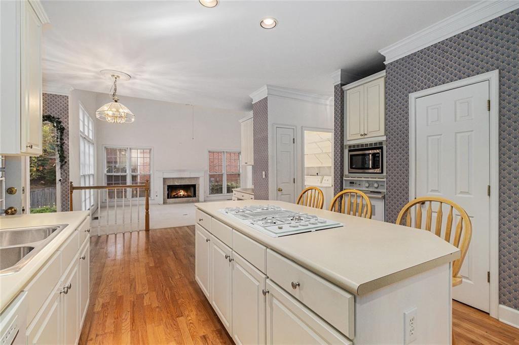 2653 Danforth Lane Decatur, GA 30033 - Photo 11 of 30 a large kitchen with kitchen island a stove a sink a dining table and chairs
