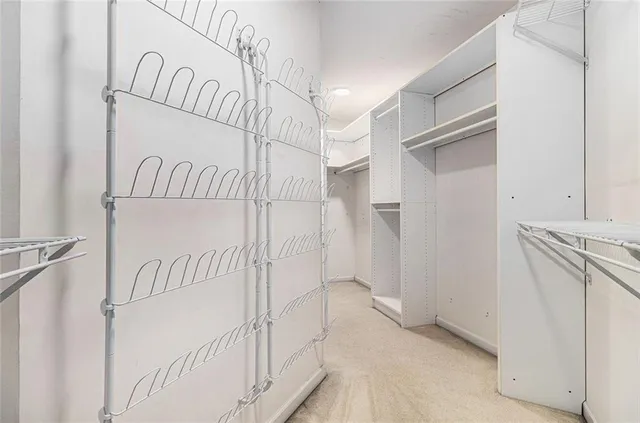 a view of an empty room with window and cabinet