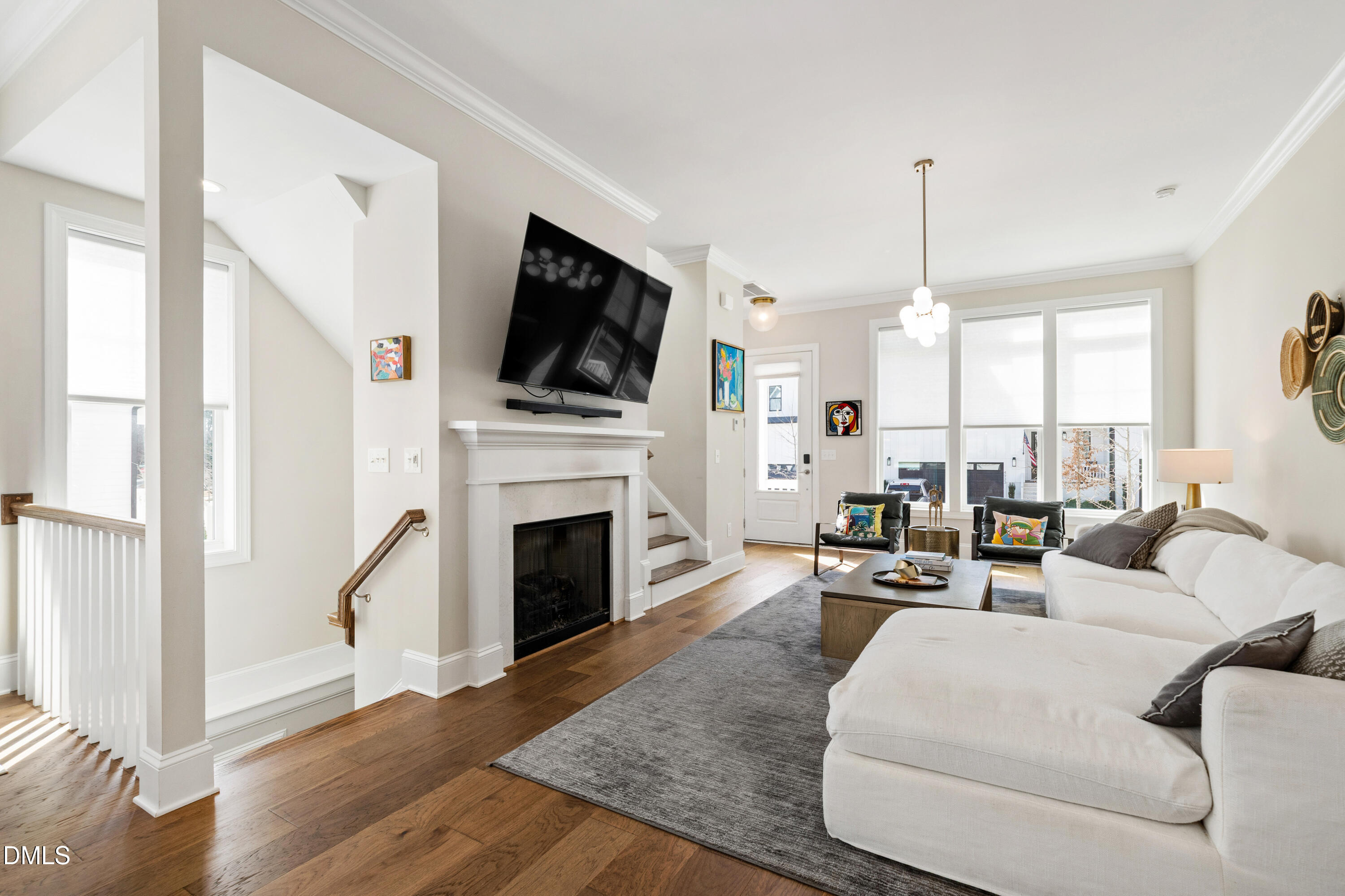 4934 Trek Lane Raleigh, NC 27606 - Photo 17 of 35 a living room with furniture a fireplace and a flat screen tv