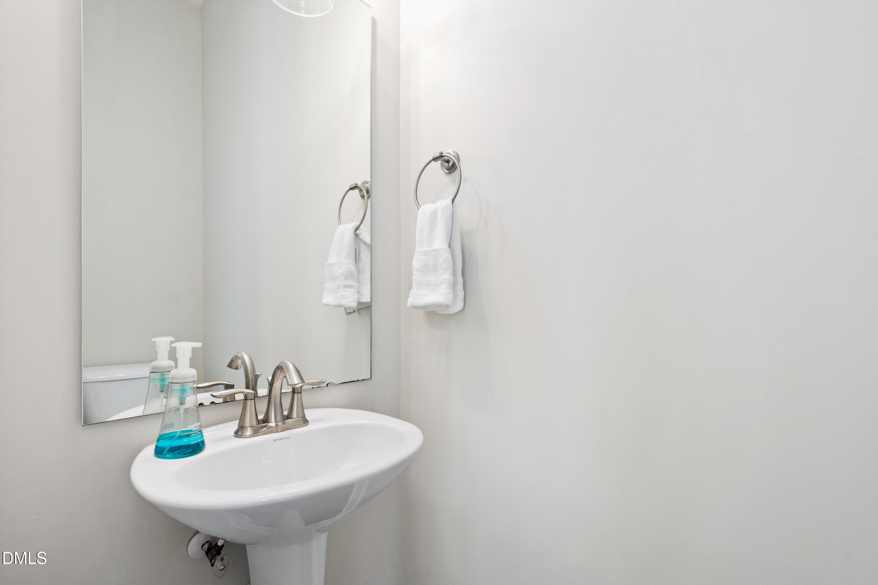 4934 Trek Lane Raleigh, NC 27606 - Photo 19 of 35 a bathroom with a sink and a mirror