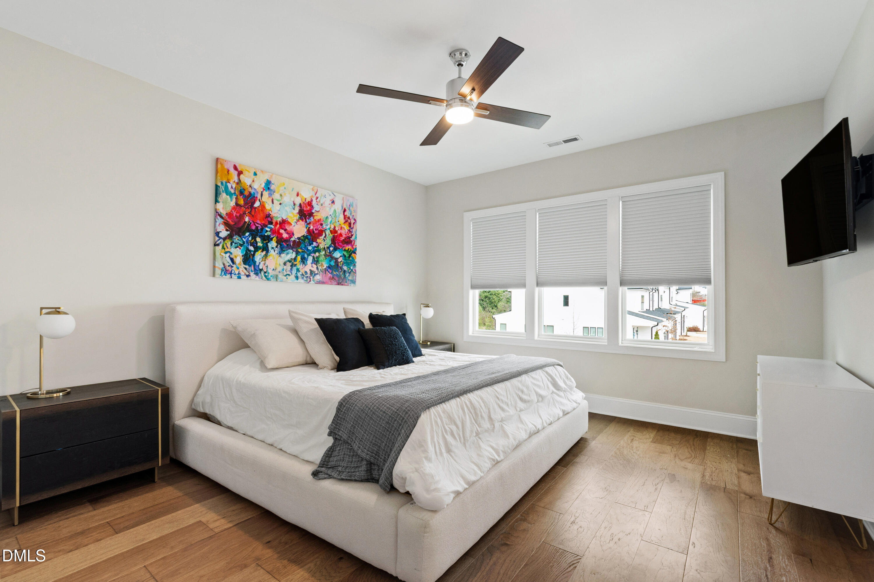 4934 Trek Lane Raleigh, NC 27606 - Photo 21 of 35 a bedroom with a bed and a flat screen tv