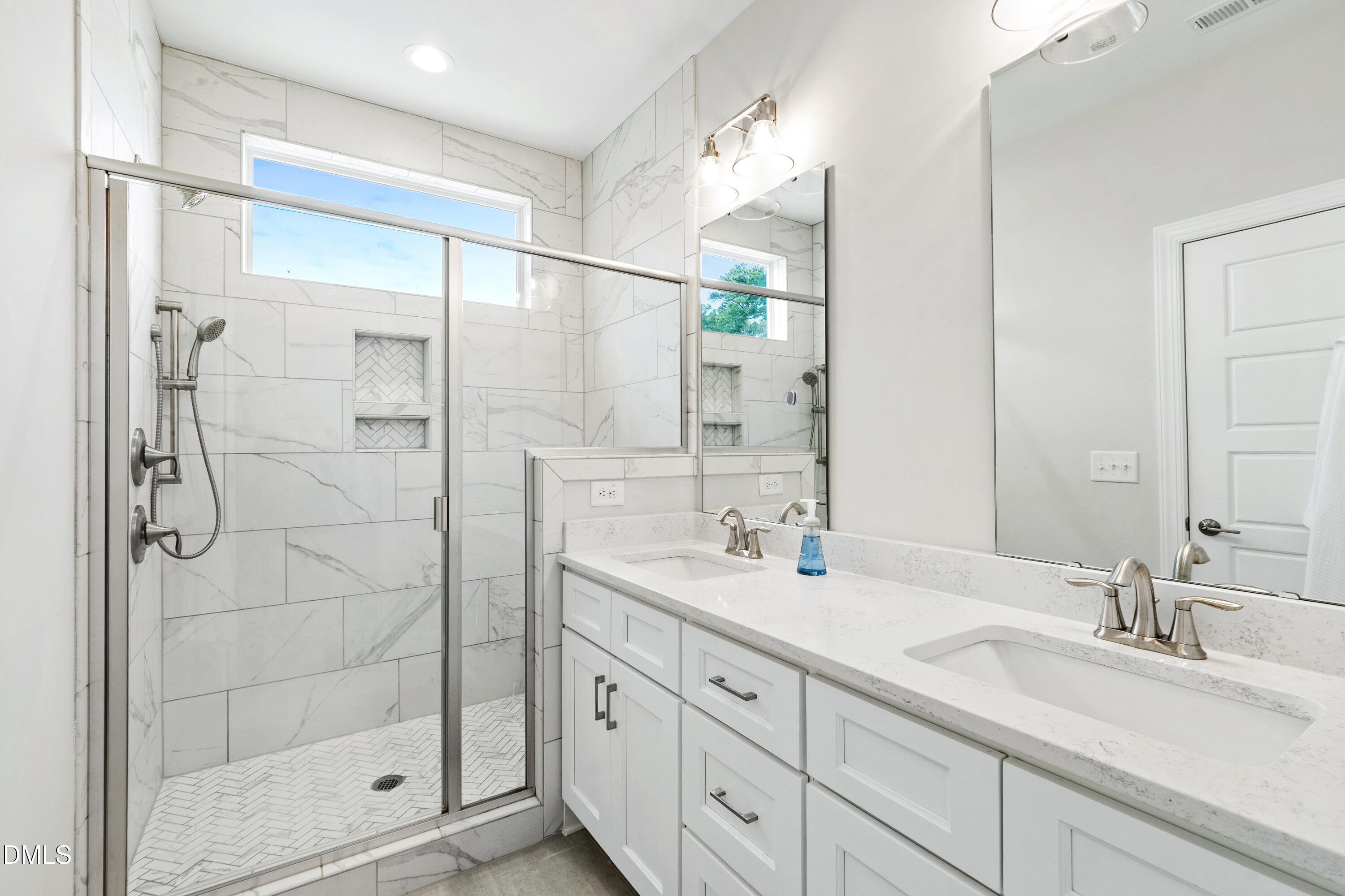 4934 Trek Lane Raleigh, NC 27606 - Photo 24 of 35 a bathroom with a shower sink and mirror